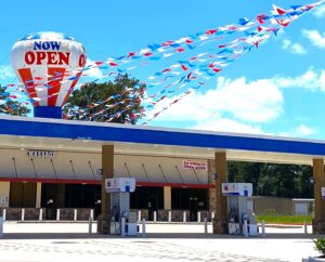 gas station convenience store with streamer pennants and large inflatable advertising on it