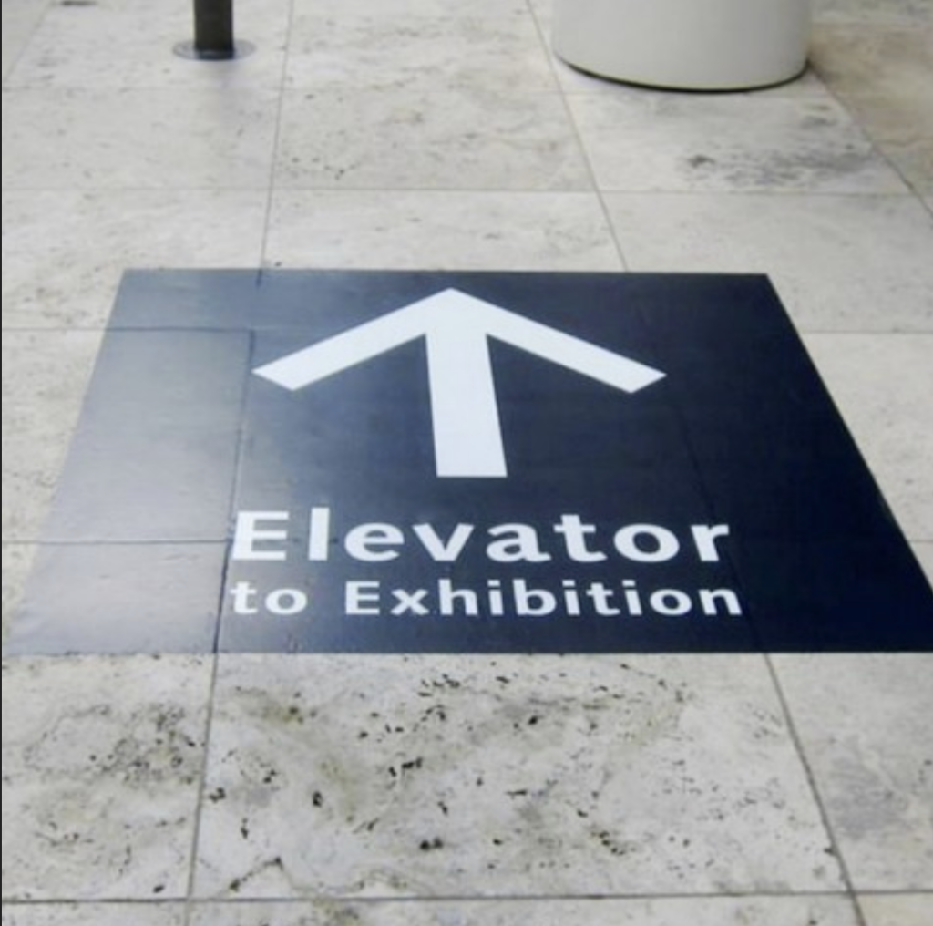 floor graphics directional elevator to exhibition with arrow