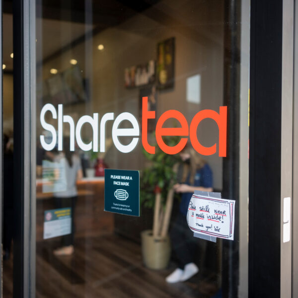 Lake Oswego, OR, USA - May 22, 2021: A sign at the entrance to the Sharetea, a bubble tea shop in Lake Oswego, Oregon, asks customers to still wear a mask, after CDC announced its new mask policy.