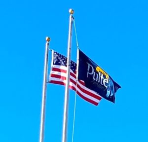 Pulte Flag flying next to American flag